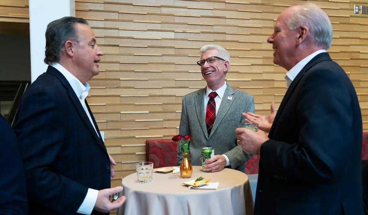 Board members and university leadership in conversation.